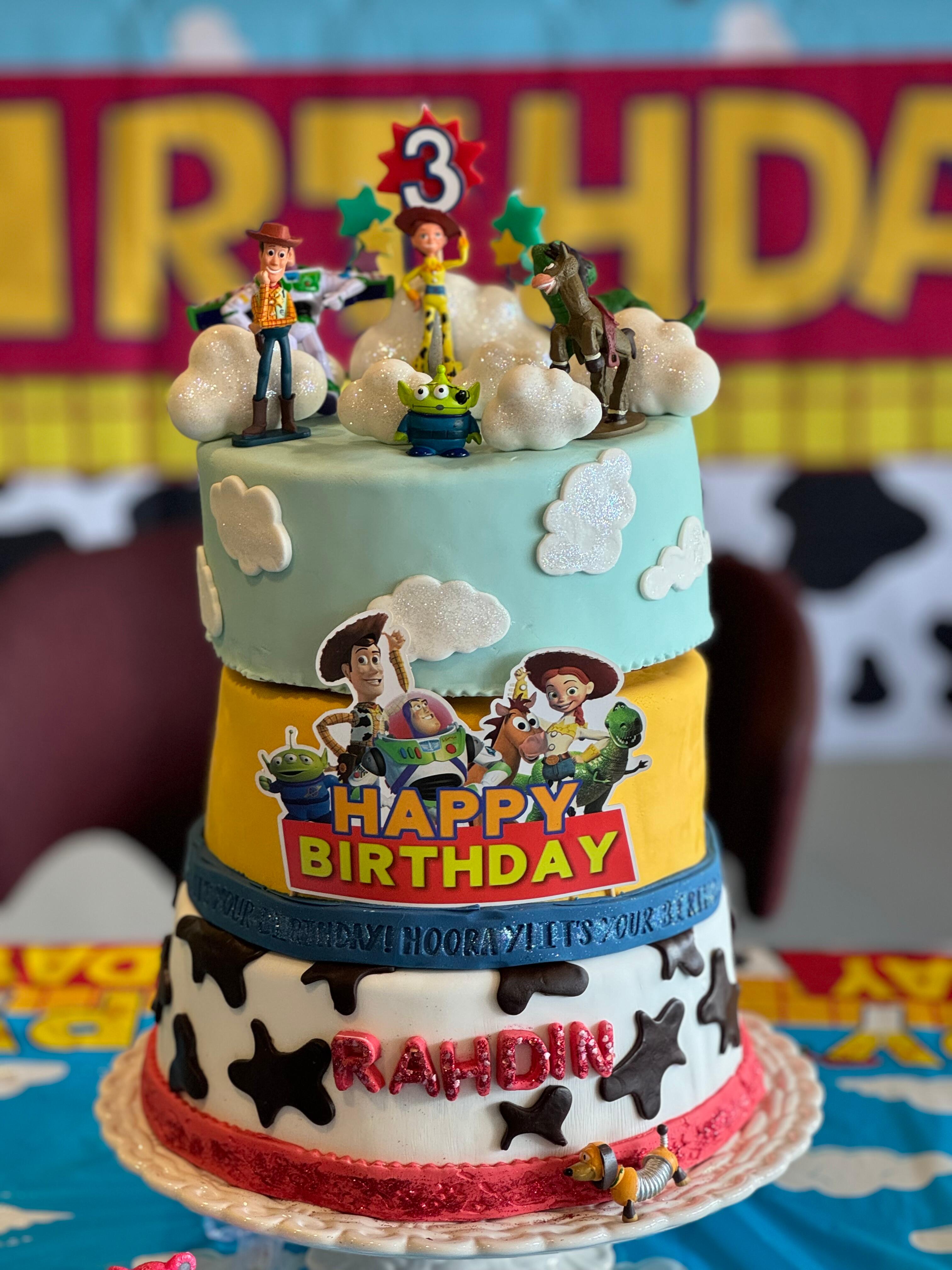 A birthday cake with toy story characters on it.